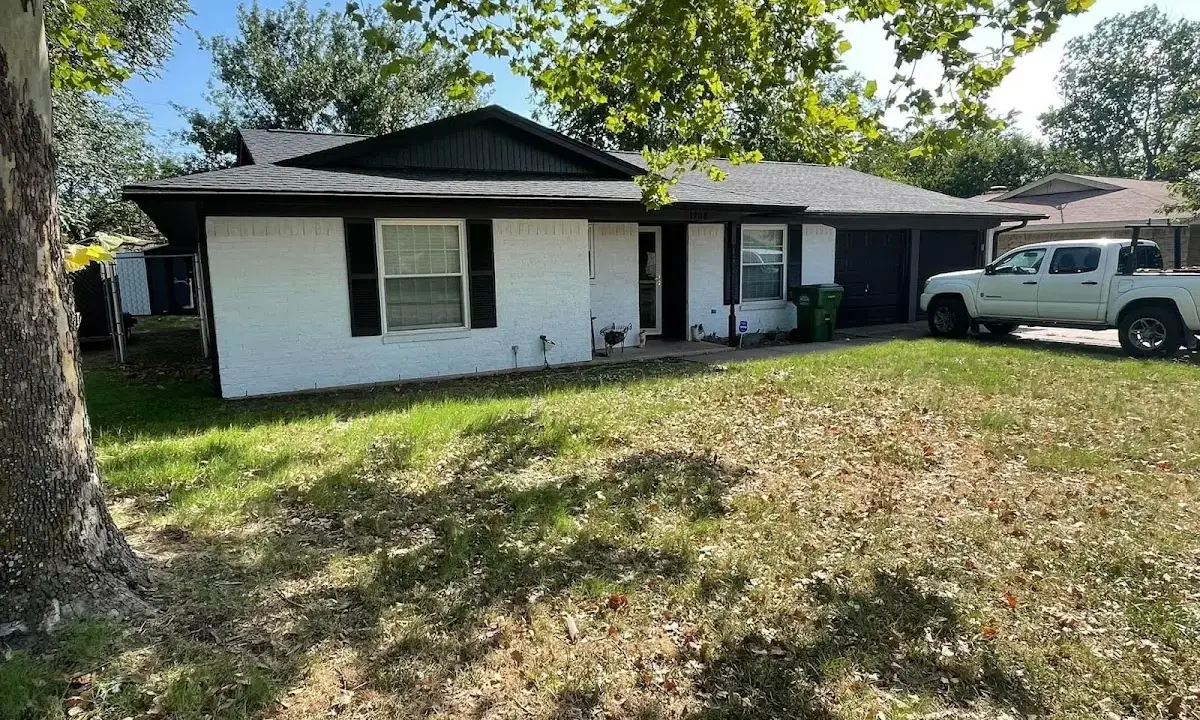 Professional roofing crew working on a residential roof in Watertown
